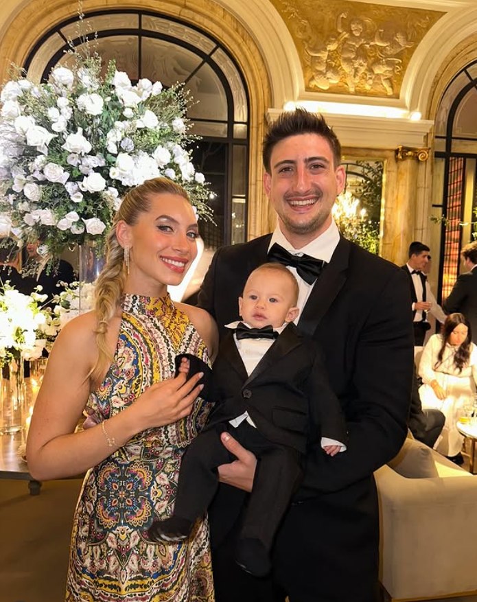 Deborah Szwarc, founder of LUXORA & CO Events, with her family at a floral archway in Miami