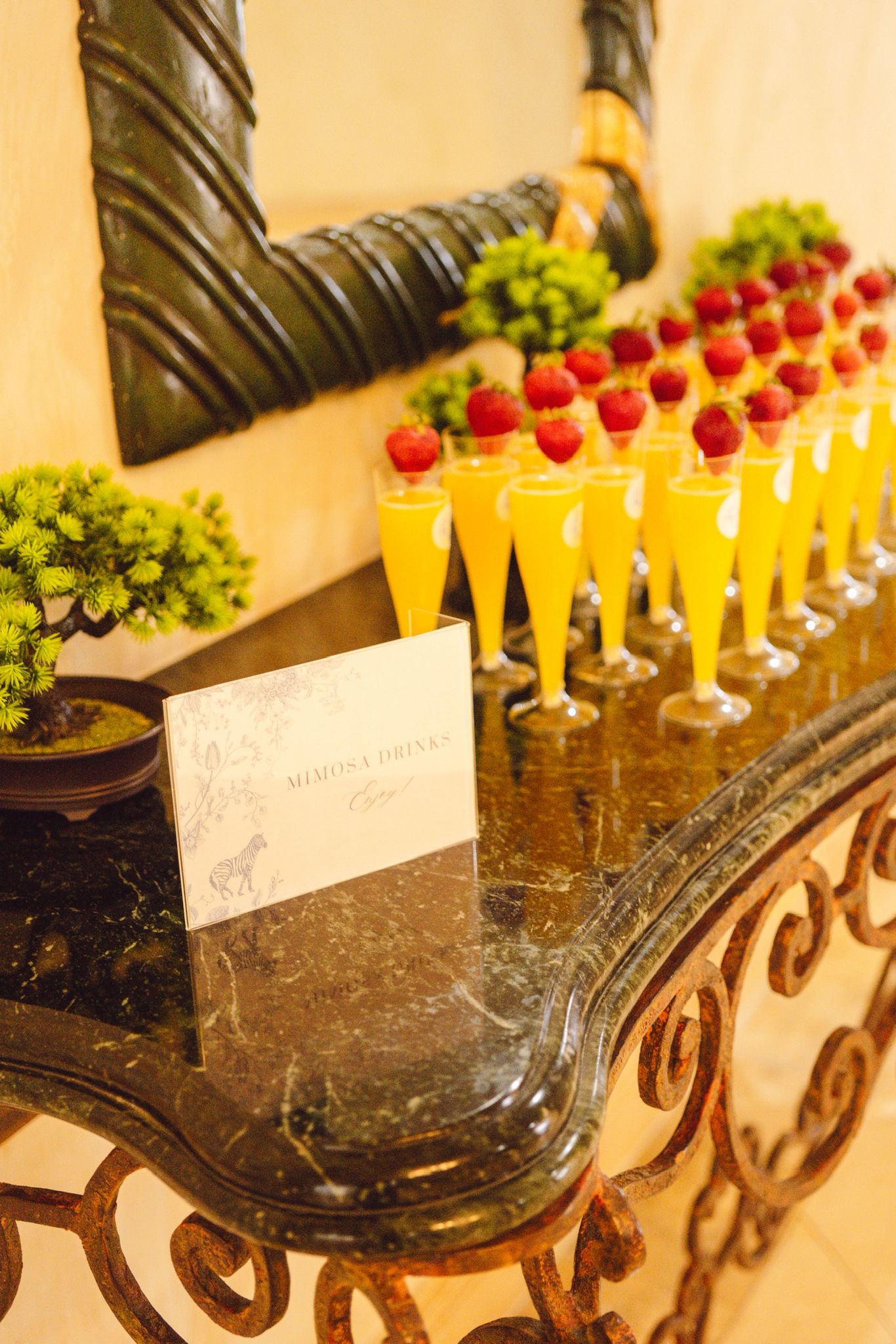 Luxury brunch styling — strawberry-topped mimosa bar and signage